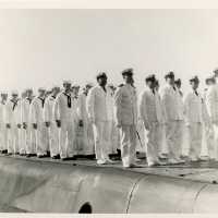 A group of men in uniform standing on a ship