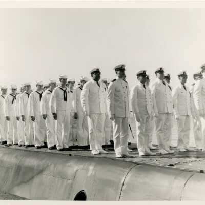 A group of men in uniform standing on a ship