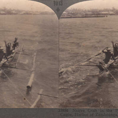 Stereoview of a men in a canoe in the Philippines