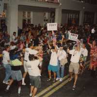 A group of unknown people walking in the street for the parade.
