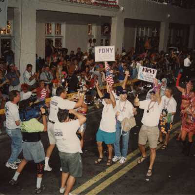 A group of unknown people walking in the street for the parade.