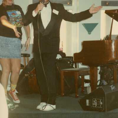 An unknown man speaking on a stage.