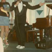 An unknown man speaking on a stage.