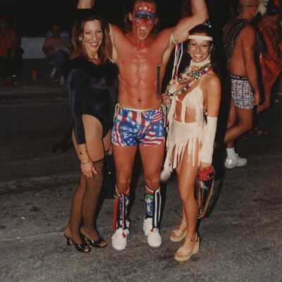 Three unknown people dressed up.