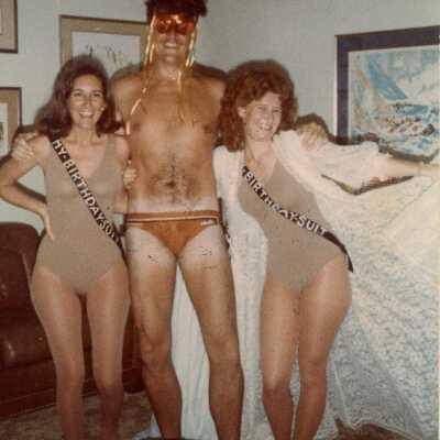 3 Unknown people dressed up for a party