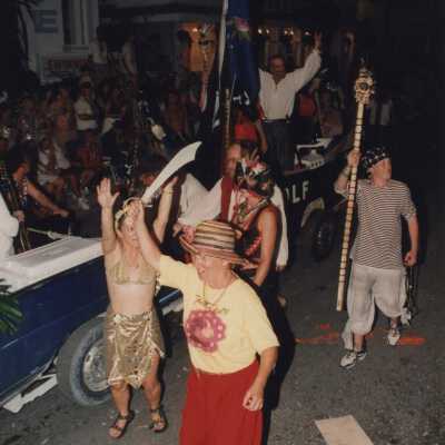 Unknown people dressed up walking in the street for the parade.