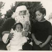 2 Unknown boys sitting with Santa Clause