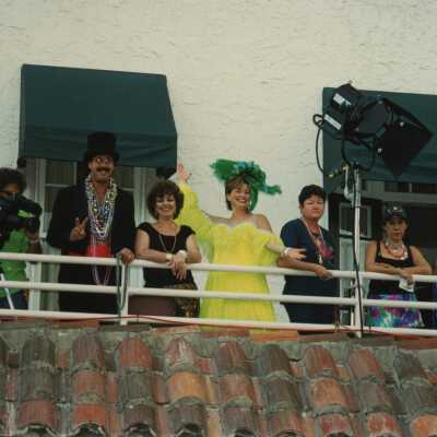 Unknown people standing on a balcony.