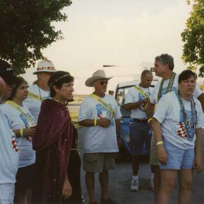 A group of unknown people standing around.