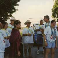 A group of unknown people standing around.