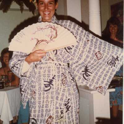 An unknown woman holding a fan