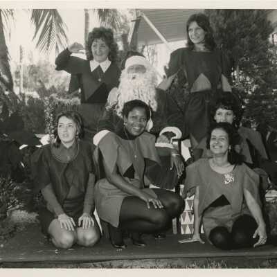 A group of woman sitting with Santa Claus