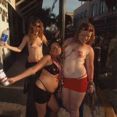 Three unknown people dressed up.