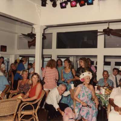 A group of unknown people standing and sitting.