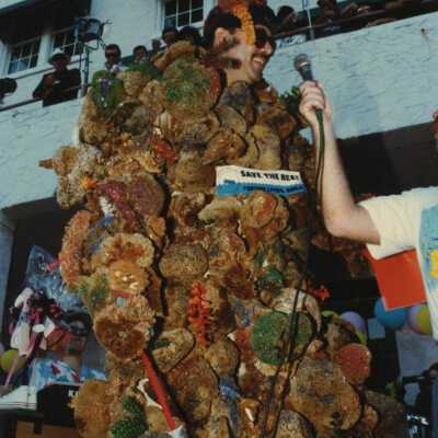 Unknown man dressed up with sea sponges.