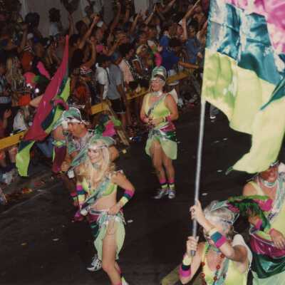 Unknown people dressed up walking in the street for the parade.