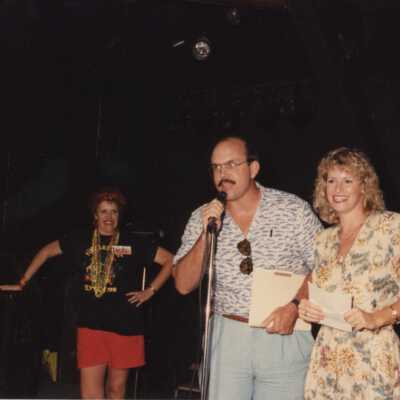 Unknown people on stage, one is talking into a microphone.