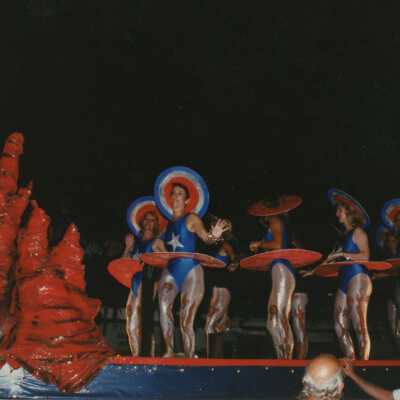 Unknown people dressed up on a float in the parade.