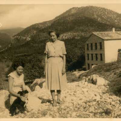 Unknown woman with a dog in a yard