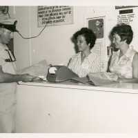 2 Unknown woman working a counter