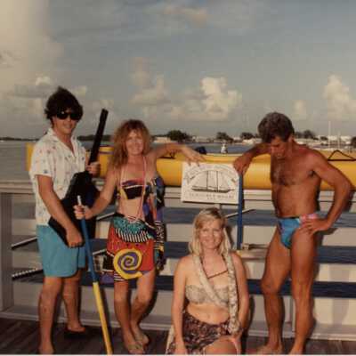 Unknown people standing by the water dressed up.