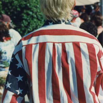 Unknown man with a shirt on that looks like a flag.