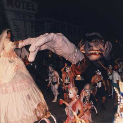 Unknown people dressed up with a few floats at the parade.