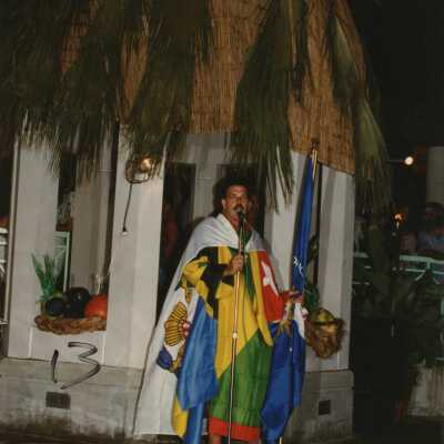 Unknown person dressed up talking near a pool.