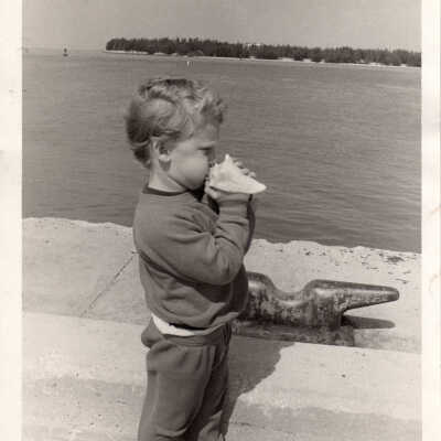 Young boy with conch shell