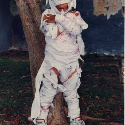 A child dressed up as a mummy for Children's Day.