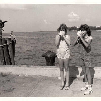 Two girls with conch shells