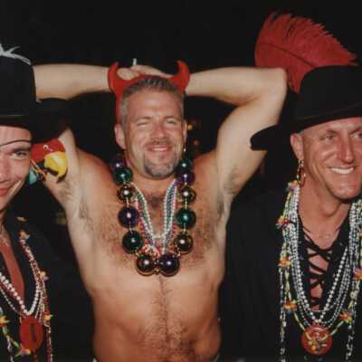 Three unknown men dressed up.