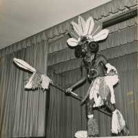 An unknown man in costume dancing on a stage