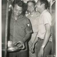 3 Unknown men in uniform in a ship