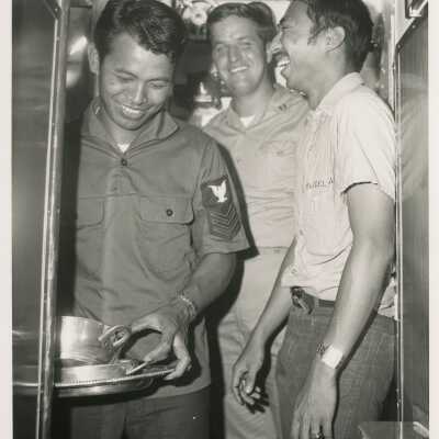3 Unknown men in uniform in a ship