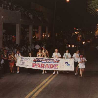 Unknown people holding the fantasy fest banner.