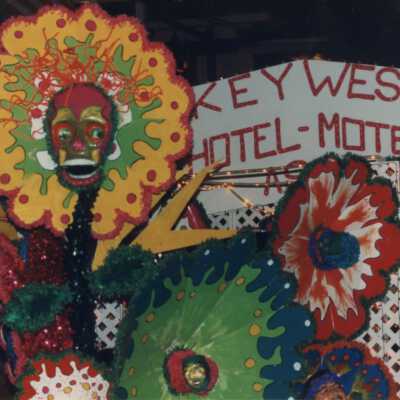 Fantasy Fest float in the parade with a Key West Hotel Motel sign.
