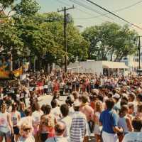 A huge group of unknown people in the street in front of the Woman