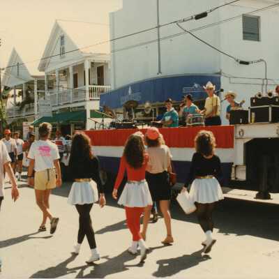 Unknown people walking near a stage.