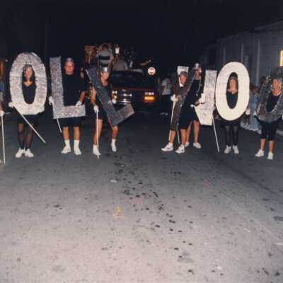 Unknown people holding letters that make up the word Hollywood.
