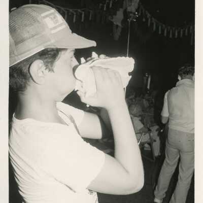 An unknown child blowing in a conch