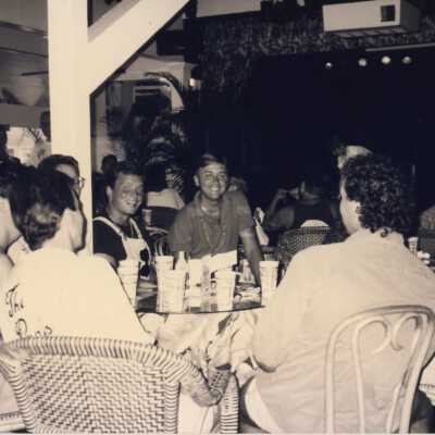 Unknown people sitting at a table talking.