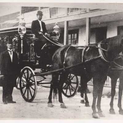 Horse-drawn hearse and two men