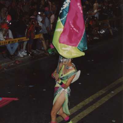 Unknown woman dressed up walking in the parade.