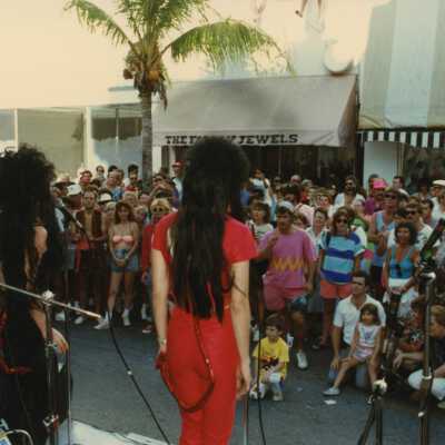Unknown people on a stage facing a crowd.
