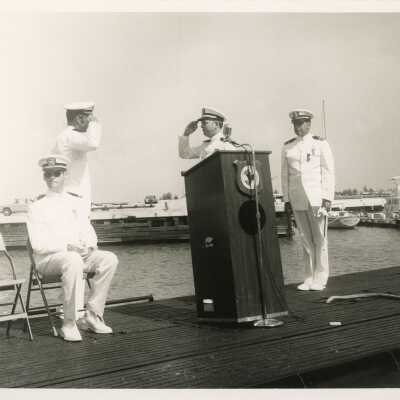 Men in uniform at the podium at a ceremony