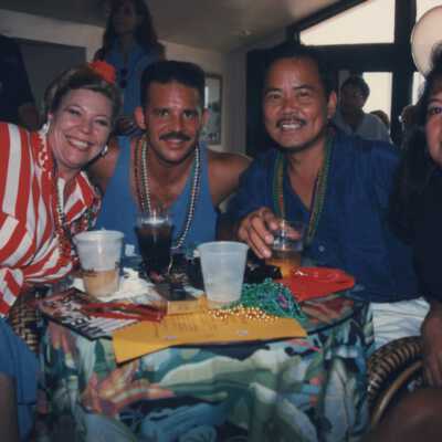 Unknown people sitting at a table talking.