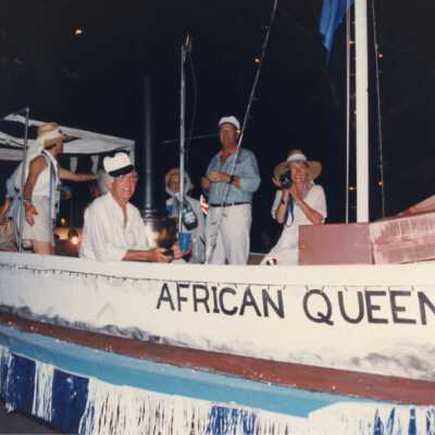 Unknown people dressed up on a float that reads African Queen.