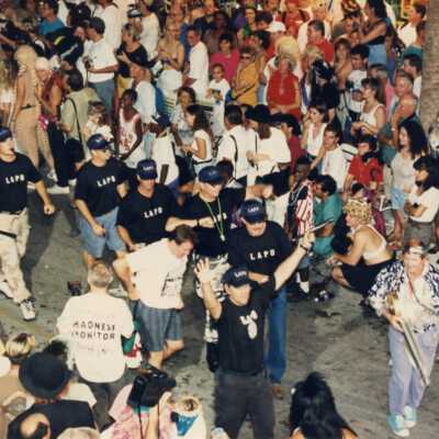 Unknown people walking in the street for the parade.