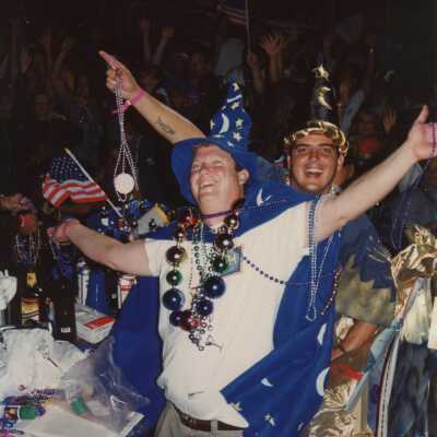 Two unknown guys dressed up on a float in the parade.